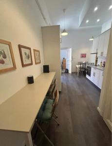 a kitchen and living room with a large counter and chairs at Leo Heart Rooms in Budapest +2 photos