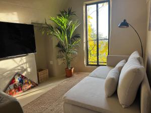 a living room with a couch and a tv at La Torretta in Arma di Taggia