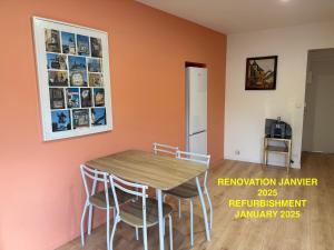 a kitchen with a table and chairs in a room at Les Appartements Chambon in Sarlat-la-Canéda +7 photos