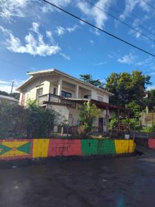 a house with a colorful wall in front of it at BBV Properties in Belmont