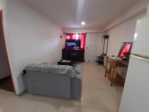 a living room with a couch and a television at Morada del sur in Ushuaia