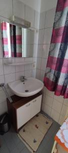 a bathroom with a sink and a mirror at Charming Apartment near Nature and Mercedes in Sindelfingen