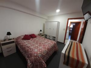a bedroom with a bed and a dresser and a desk at Morada del sur in Ushuaia