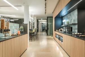a lobby of a store with a counter and chairs at Art Hotel Ahlen in Ahlen