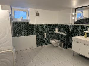 a bathroom with a toilet and a sink at Barbat Home-Ferienwohnung im Alexanderstraße in Hamburg +66 photos