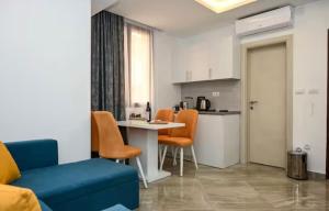 a living room with a table and chairs and a kitchen at Portobello in Tivat