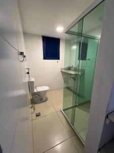 a bathroom with a glass shower and a toilet at Casa Baleia Lagoa in São Pedro da Aldeia +29 photos