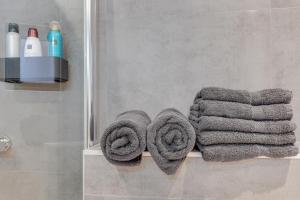 a towel rack with towels on it in a bathroom at B&B aan de Gracht in Alkmaar +44 photos