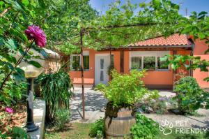 a house with a garden in front of it at Garden House in Matulji