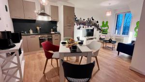 a kitchen and living room with a table and chairs at KIKOR, belle vue sur le Loiret in Saint-Pryvé-Saint-Mesmin