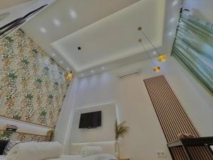 a living room with a tv on a wall at The Pest Garden Condo A in Budapest
