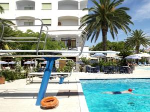 un hombre nadando en una piscina en un hotel en Grand Hotel Don Juan, en Giulianova
