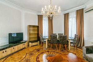 a dining room with a table and a chandelier at Apartment Azercell in The Fountain in Baku