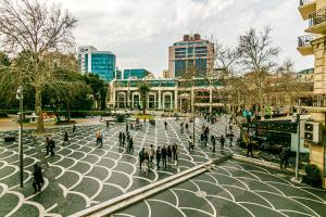 a group of people walking on a city street at Apartment Azercell in The Fountain in Baku