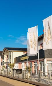 a building with two flags in front of it at Hotel Residenz Babenhausen in Babenhausen
