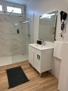 a bathroom with a white sink and a shower at Achadinha Sunset House in Achadinha +31 photos