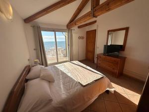 カオルレにあるATTIC PARADISE Big Terrace on the Sea - AGENZIA COCALのベッドと大きな窓のある寝室