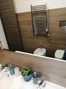 a bathroom with two sinks and a mirror at Al Crocevia in Bologna
