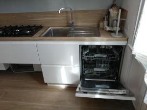 a kitchen with a sink and a dishwasher at Al Crocevia in Bologna +21 photos