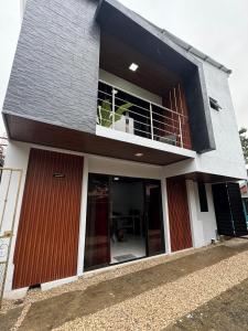 a large house with a balcony and a balcony at Villa JADE, La Fortuna Downtown Groups in Fortuna