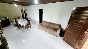 a living room with a couch and a table at Casa na praça do Carananduba in Belém