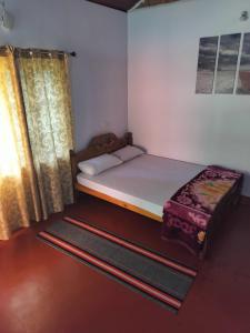 Postel nebo postele na pokoji v ubytování Madan Homestay