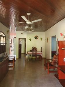 a living room with a table and chairs and a ceiling at Aconchego do Viana in Belém