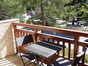 une table et deux chaises assises sur un balcon dans l'établissement Studio confortable 4 pers, centre, pistes, balcon - FR-1-516-122, à Les Deux Alpes