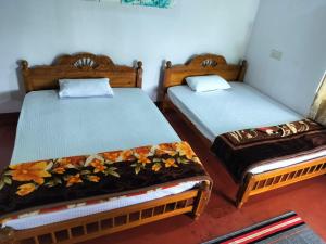 Postel nebo postele na pokoji v ubytování Madan Homestay