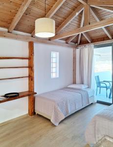 a bedroom with a bed in a room with a window at Lux home in central location in Ierápetra