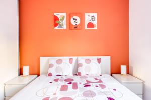 a bedroom with a bed with an orange wall at Terracotta Room - Proche Stade de France & CDG & Paris in Saint-Denis +27 photos