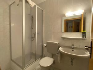 a bathroom with a shower and a toilet and a sink at Gasthaus Goa in Ernsthausen +21 photos