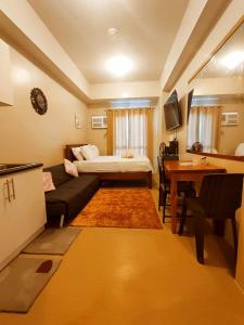 a living room with a couch and a bed at 1517 double in Iloilo City +11 photos