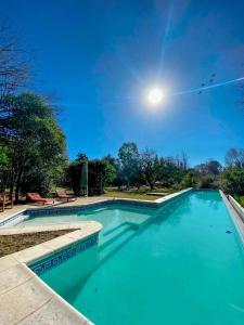a swimming pool with the moon in the sky at Puesto de Montaña - Casa con pileta privada in Los Hornillos