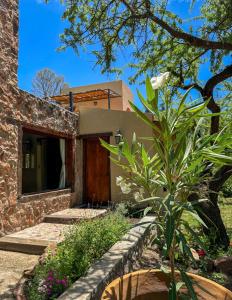 a house with a garden in front of it at Puesto de Montaña - Casa con pileta privada in Los Hornillos +32 photos