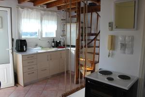 a kitchen with a sink and a stove in it at Olive Tree House II in Dhermatiánika