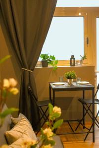 a table and chair with a table and a window at CITY FLATS - Avenida Baleares in Valencia