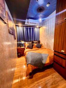a bedroom with a bed with a blue ceiling at Azure Urban Resort Staycation by Solace Peak 2 bedrooms in Manila