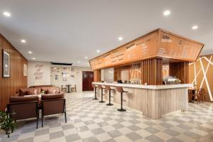 a lobby with a bar and a counter with chairs at Angkor Mansion & Residence in Siem Reap