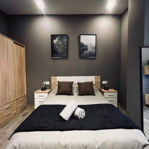 a bedroom with a large bed with three pictures on the wall at CITY FLATS - Avenida Baleares in Valencia