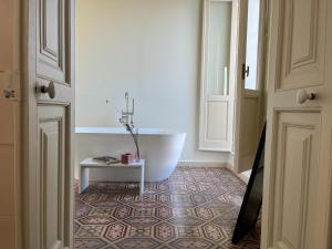 a bathroom with a tub in the corner of a room at Dimora la Fuga in Zollino