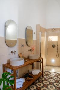 a bathroom with two sinks and a shower at Dimora la Fuga in Zollino +53 photos