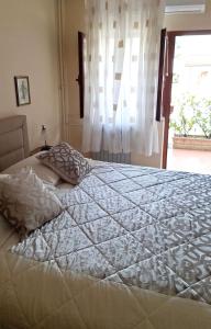 a large bed in a bedroom with a window at Room Vera- with airconditioning and free parking in Mošćenička Draga +20 photos