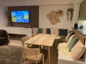 a living room with a table and a couch at Orlyvo appartement Middelkerke in Middelkerke
