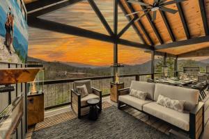 a room with a couch and chairs on a balcony at Heated Pool - Incredible Sunsets - Designed 4 FUN in Sevierville