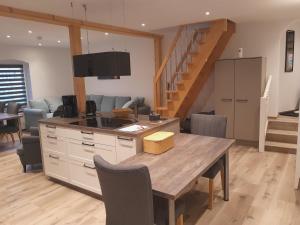 a kitchen and dining room with a table and stairs at Thonic 1 in Quedlinburg