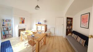 a living room with a table and a dining room at Maureen's Hideaway in Penrith