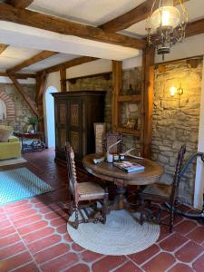 a dining room with a wooden table and chairs at Sokograd Royal in Šipovo