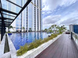 a large building with a swimming pool in front of it at Panoramic Seaview Studio High-Floor and Free WiFi in Batam Center