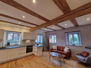 a kitchen and living room with a couch and a table at Marienhof in Geisfeld